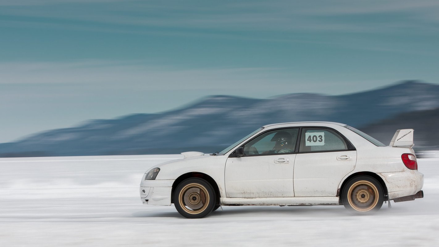 A member of the Adirondack Motor Enthusiasts Club races their Subaru WRX across a frozen Lake George at the Lake George Winter Carnival