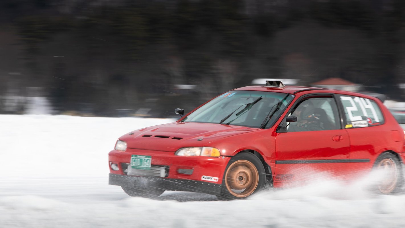 A member of the Adirondack Motor Enthusiasts Club races their Honda Civic across a frozen Lake George at the Lake George Winter Carnival